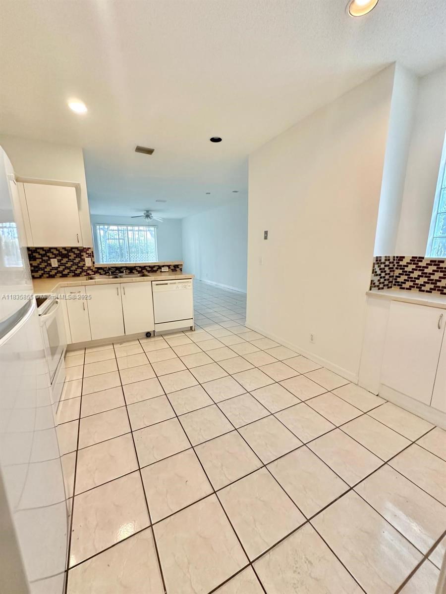 The Ridges Weston, FL 33331 - Photo 14 of 54 a kitchen with stainless steel appliances granite countertop a sink and a stove