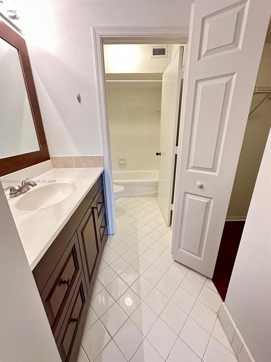 The Ridges Weston, FL 33331 - Photo 25 of 54 a bathroom with a sink a toilet and a mirror