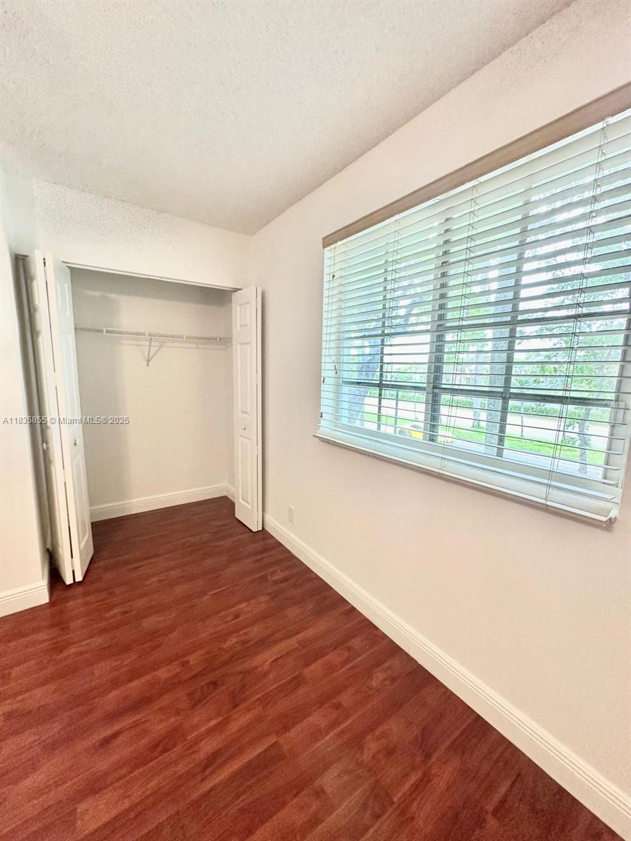 The Ridges Weston, FL 33331 - Photo 29 of 54 a view of an empty room with wooden floor and a window