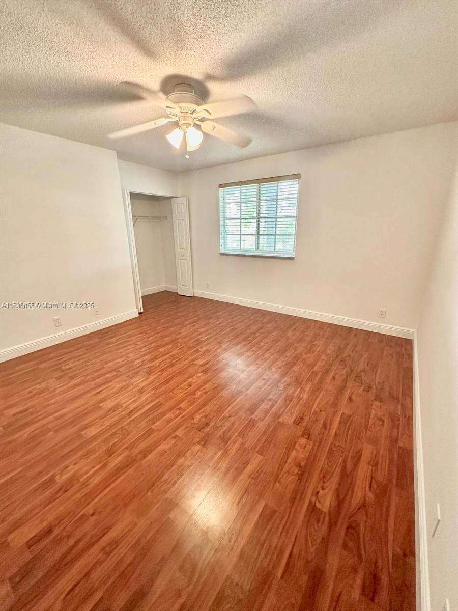 The Ridges Weston, FL 33331 - Photo 30 of 54 an empty room with wooden floor fan and windows