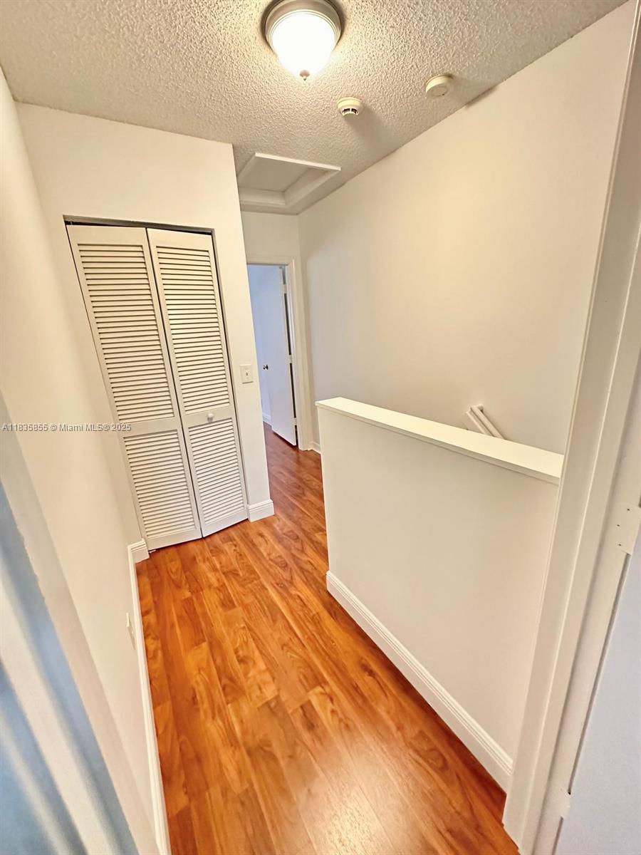 The Ridges Weston, FL 33331 - Photo 35 of 54 a view of hallway with stairs and wooden floor