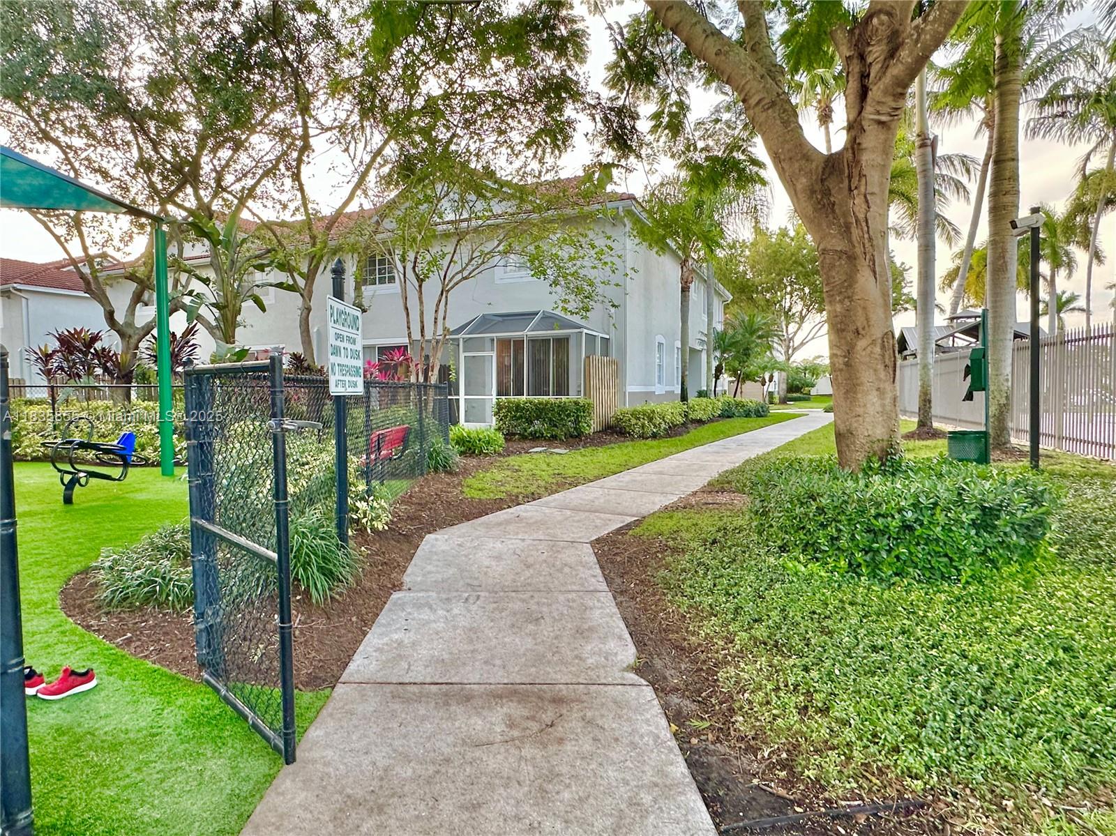 The Ridges Weston, FL 33331 - Photo 49 of 54 a front view of a house with a yard and fountain