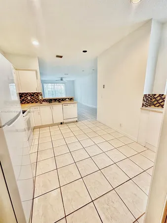 a kitchen with a sink a stove top oven and cabinets