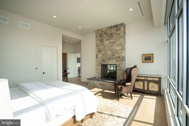 a bedroom with a bed furniture and a fireplace
