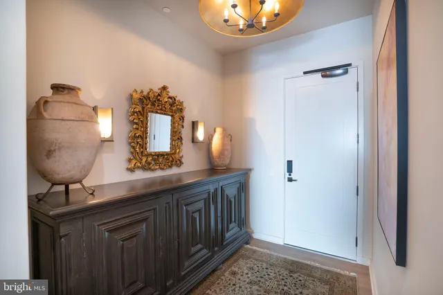 a room with a sink and chandelier