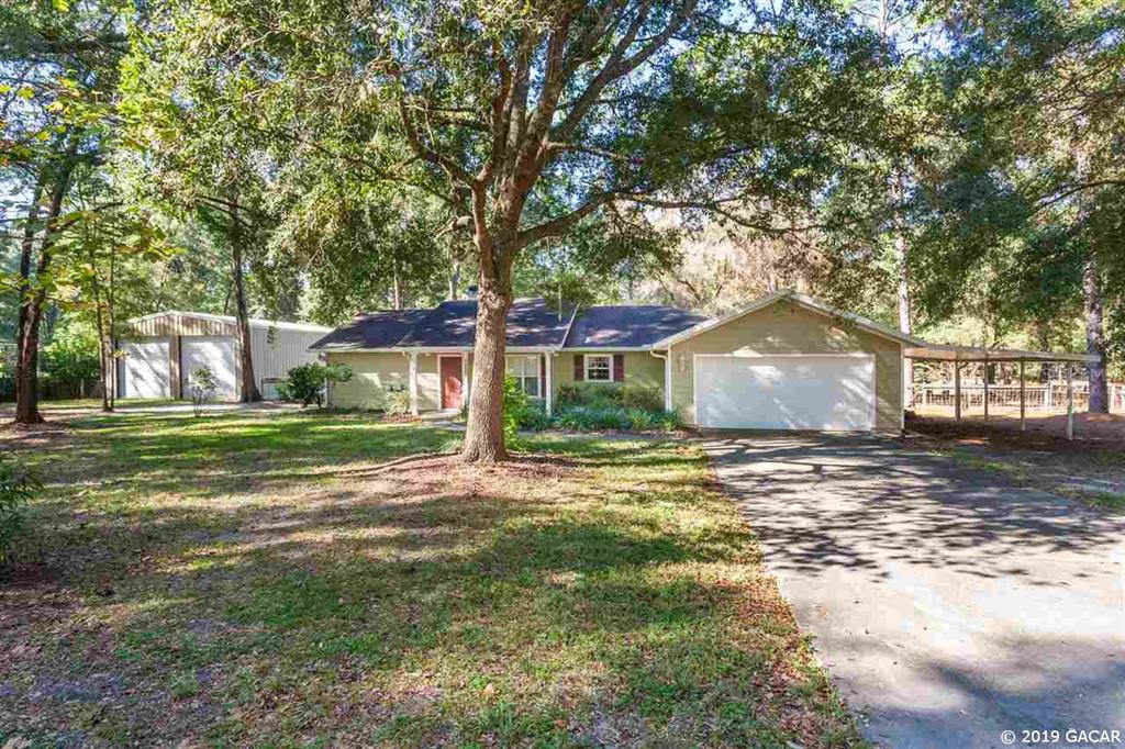 9922 Southwest 86th Terrace Gainesville, FL 32608 - Photo 1 of 1 a view of a house with a yard