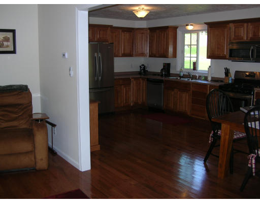163 Prince Road Southbridge, MA 01550 - Photo 5 of 11 a kitchen with a sink a stove a refrigerator cabinets and a window