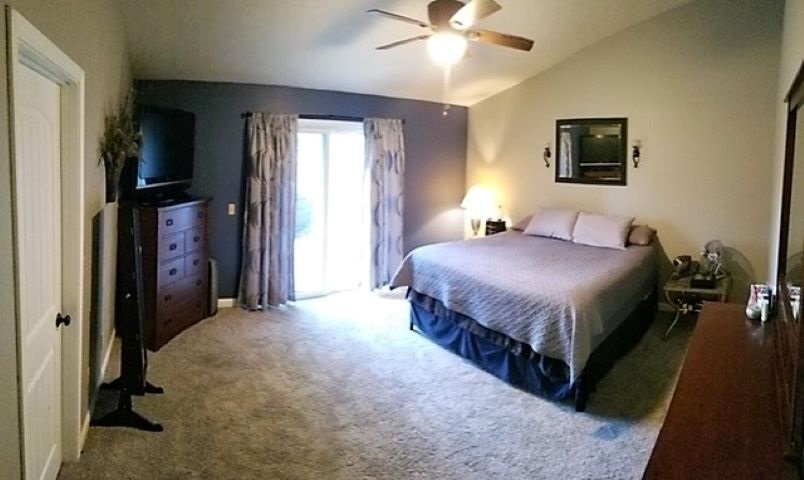 112 Pembroke Road Southwest Poplar Grove, IL 61065 - Photo 22 of 25 a spacious bedroom with a bed and a chandelier