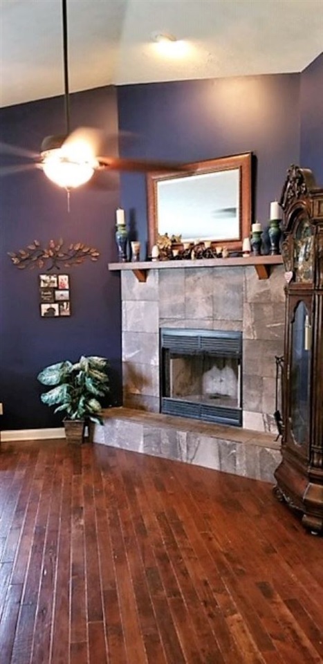 112 Pembroke Road Southwest Poplar Grove, IL 61065 - Photo 10 of 25 a living room with furniture a fireplace and a flat screen tv