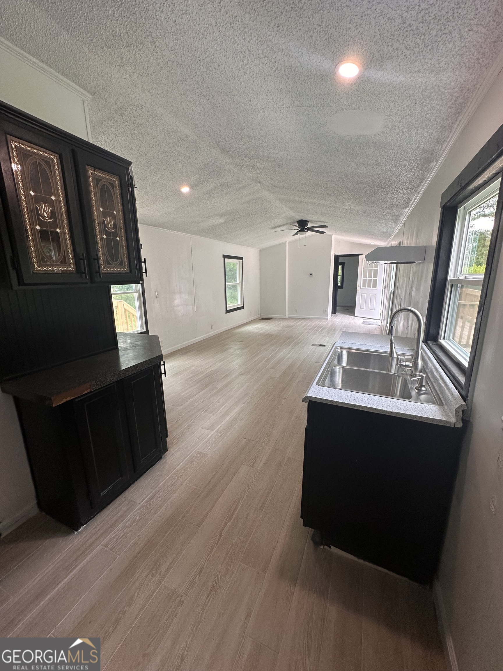 2023 Stephens Road Elberton, GA 30635 - Photo 13 of 21 a living room with large couch wooden floor and windows