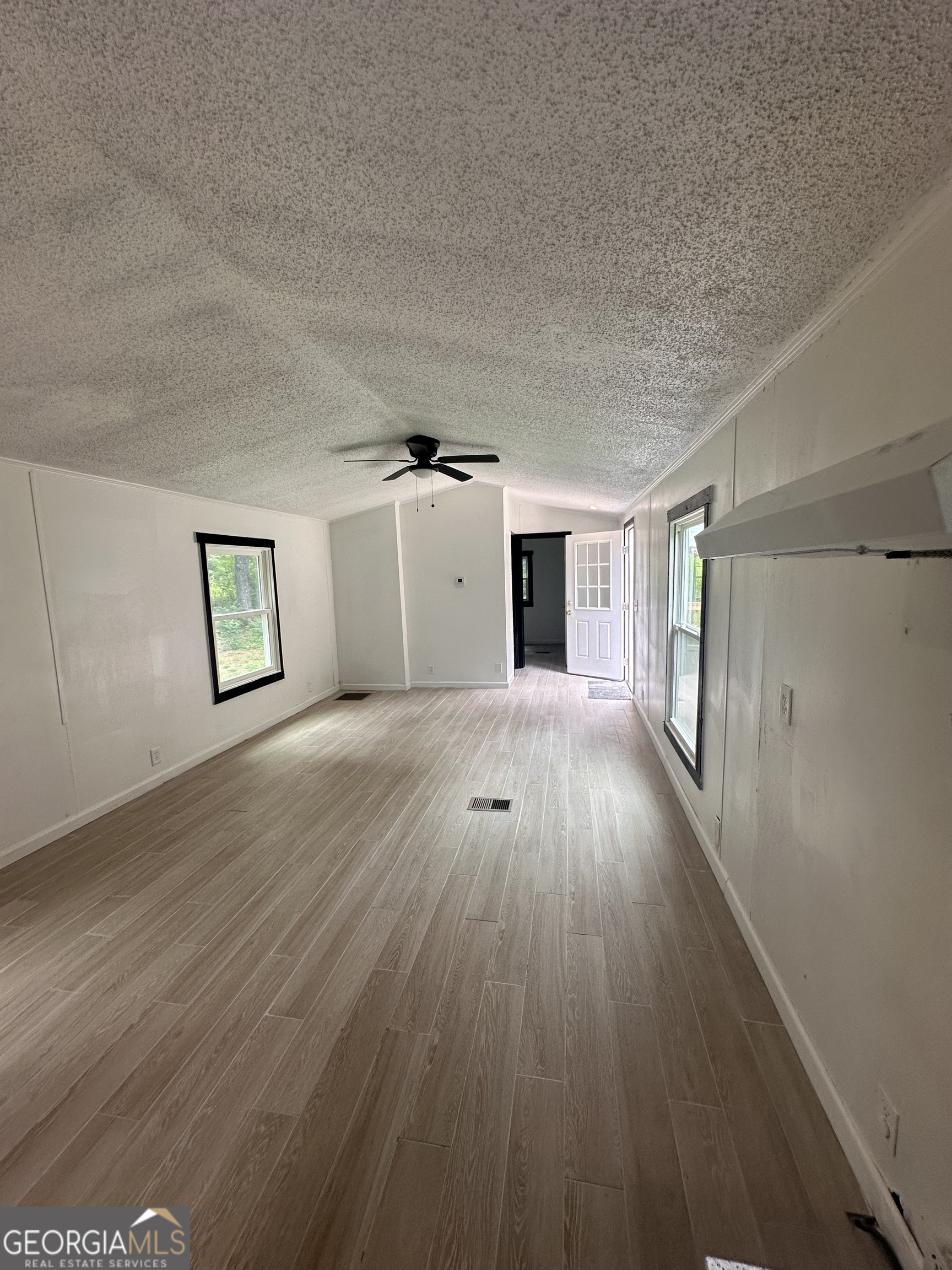 2023 Stephens Road Elberton, GA 30635 - Photo 18 of 21 a view of a big room with wooden floor and windows