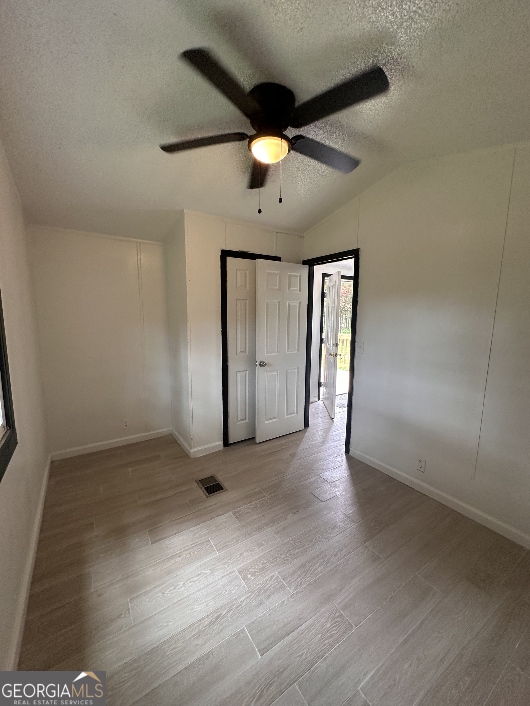 2023 Stephens Road Elberton, GA 30635 - Photo 21 of 21 an empty room with wooden floor and windows