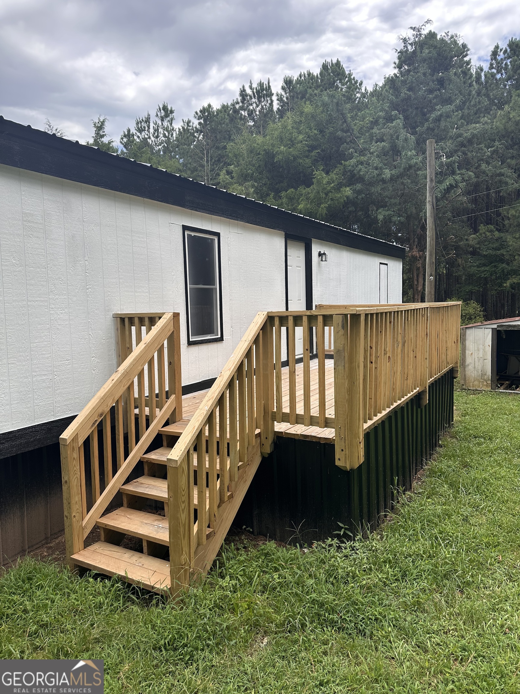 2023 Stephens Road Elberton, GA 30635 - Photo 4 of 21 a view of a house with wooden deck