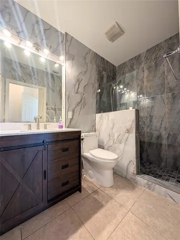 a bathroom with a toilet sink and shower