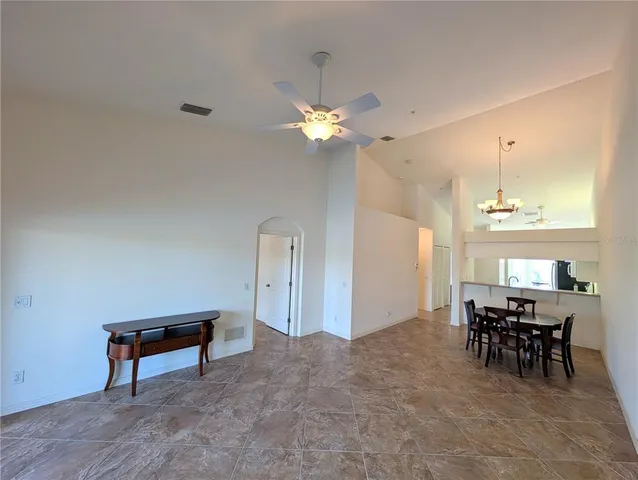 a view of a livingroom with furniture and chandelier fan