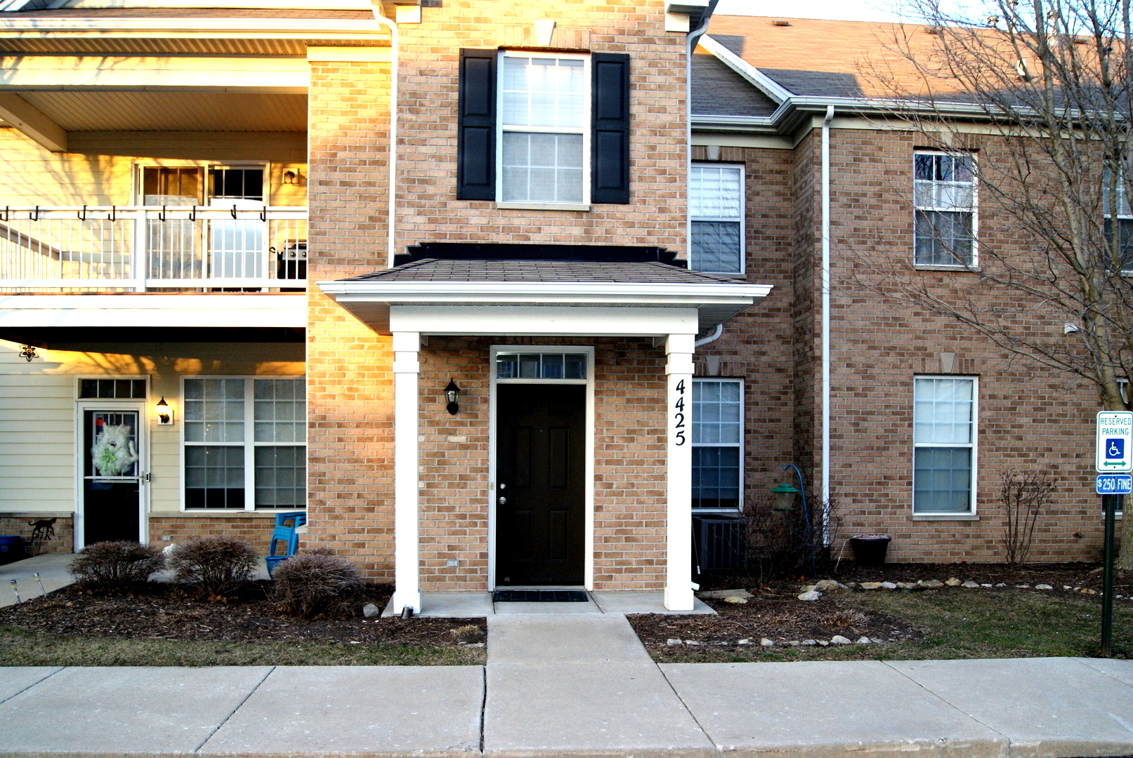 a view of a brick house with large windows