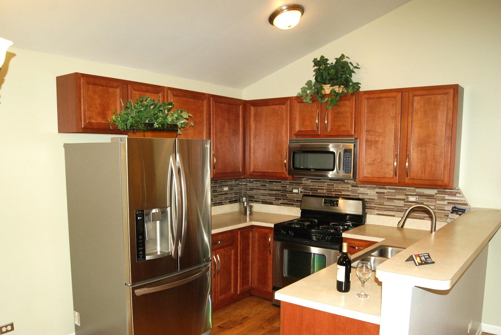 4425 Timber Ridge Court, Unit 4425 Joliet, IL 60431 - Photo 3 of 25 a kitchen with stainless steel appliances a sink stove and refrigerator