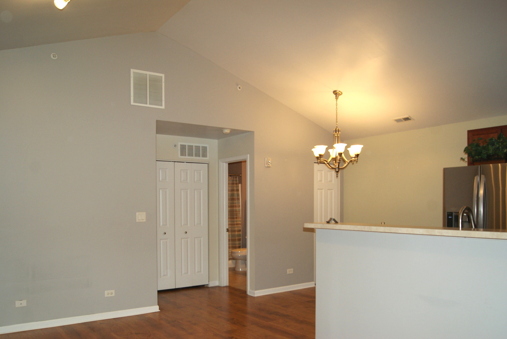 4425 Timber Ridge Court, Unit 4425 Joliet, IL 60431 - Photo 6 of 25 an empty room with wooden floor and mirror