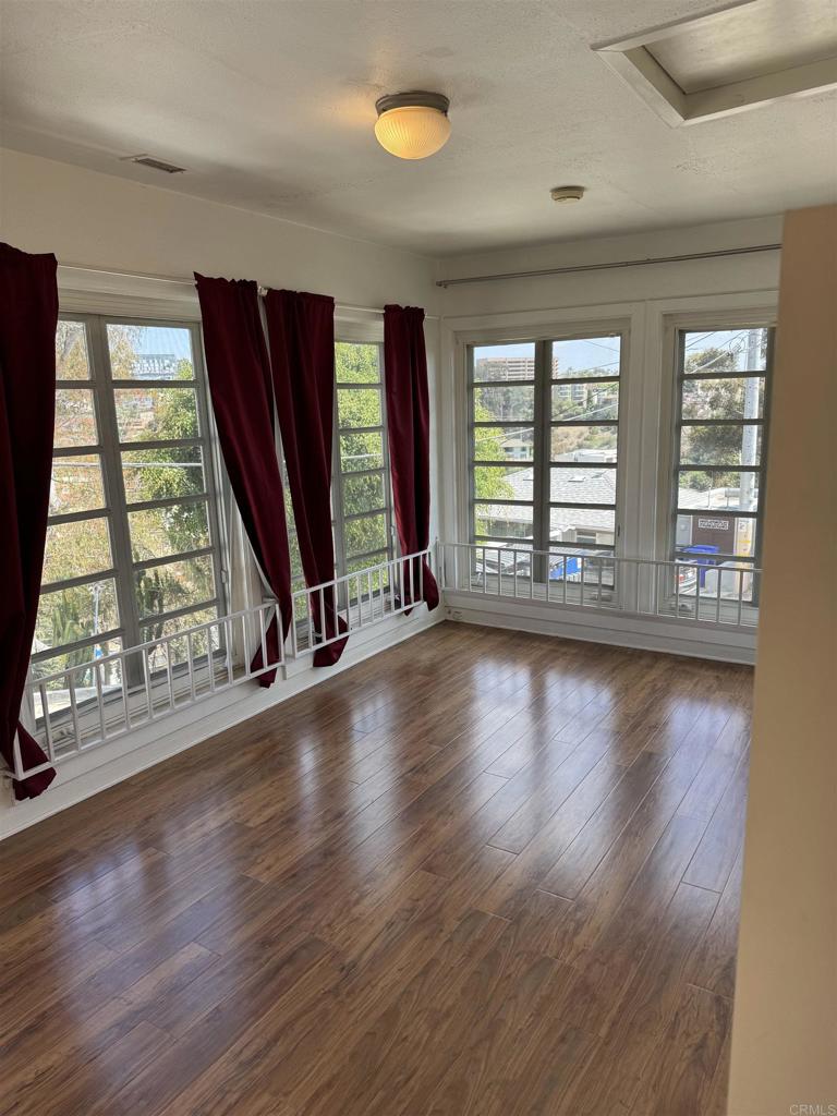 2805 State Street San Diego, CA 92103 - Photo 11 of 14 a view of an empty room with wooden floor and a window