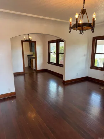 a view of a livingroom with wooden floor and a ceiling fan