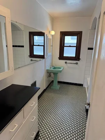 a view of a room with wooden floor and furniture