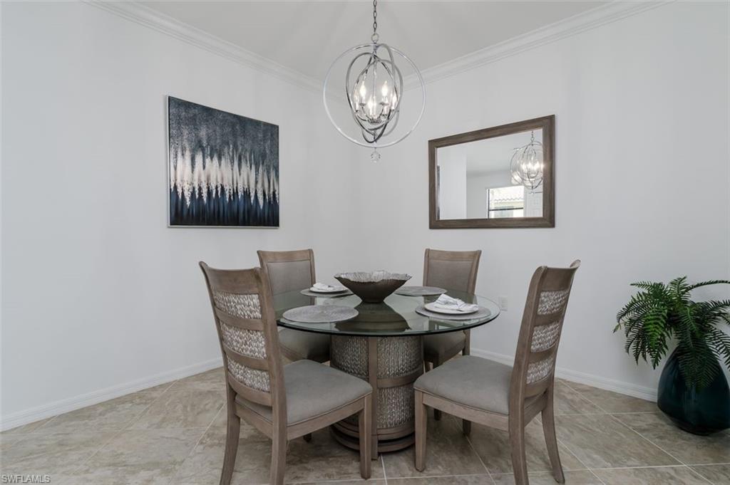 9596 Trevi Court, Unit 5431 Naples, FL 34113 - Photo 11 of 32 a view of a dining room with furniture and chandelier