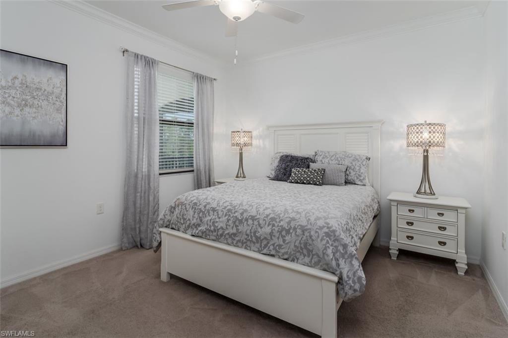 9596 Trevi Court, Unit 5431 Naples, FL 34113 - Photo 14 of 32 a bedroom with a bed and a night stand