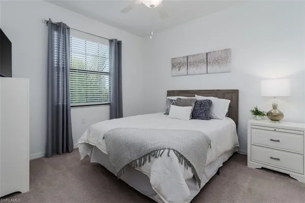 a bedroom with two beds and a chandelier