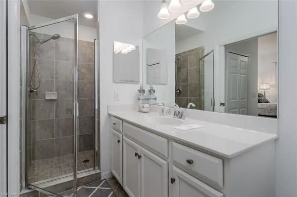 a bathroom with a double vanity sink mirror and toilet