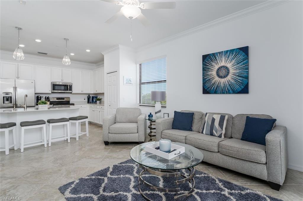 9596 Trevi Court, Unit 5431 Naples, FL 34113 - Photo 2 of 32 a living room with furniture kitchen view and a chandelier