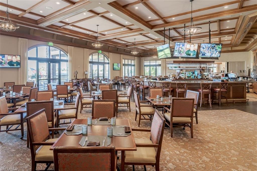 9596 Trevi Court, Unit 5431 Naples, FL 34113 - Photo 29 of 32 a view of a dining room with lots of wooden furniture