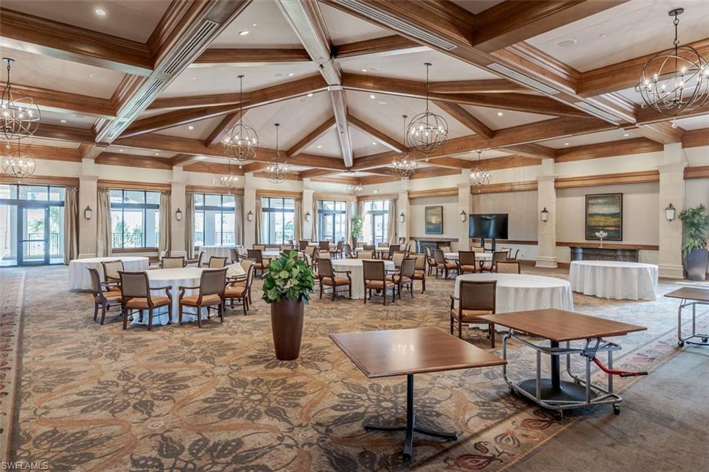 9596 Trevi Court, Unit 5431 Naples, FL 34113 - Photo 30 of 32 a living room with lots of furniture a rug and a chandelier