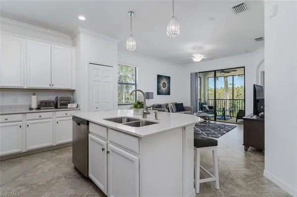 a kitchen with sink stove and cabinets