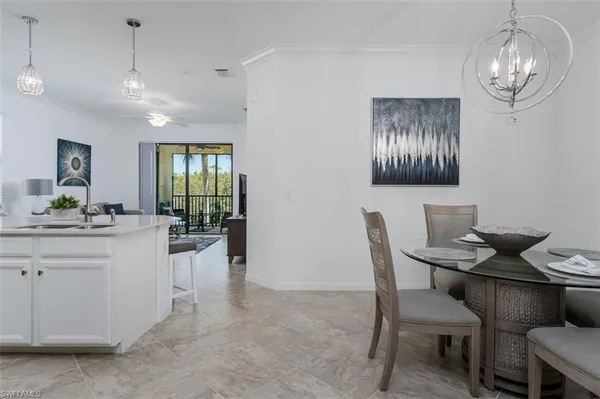 a view of a dining room with furniture and chandelier