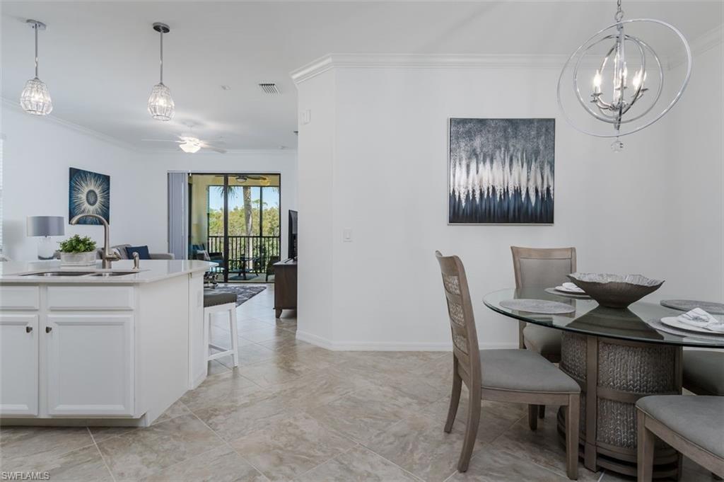 9596 Trevi Court, Unit 5431 Naples, FL 34113 - Photo 10 of 32 a view of a dining room with furniture
