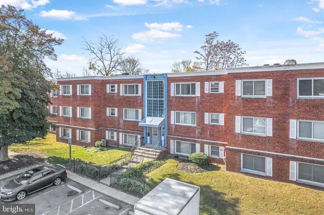 a view of a brick building next to a yard