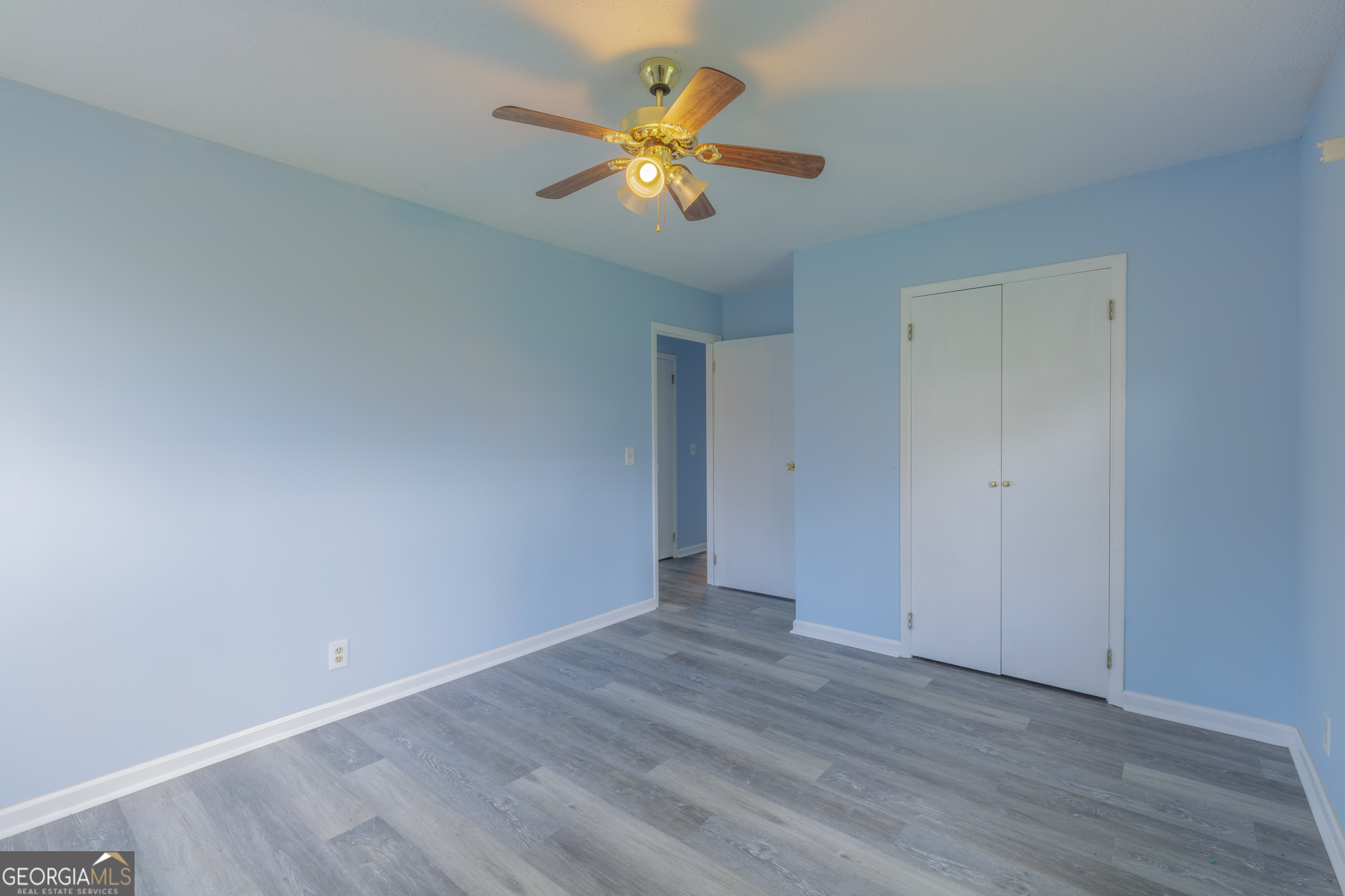 395 Wisteria Road LaFayette, GA 30728 - Photo 14 of 31 a view of an empty room with wooden floor and a ceiling fan