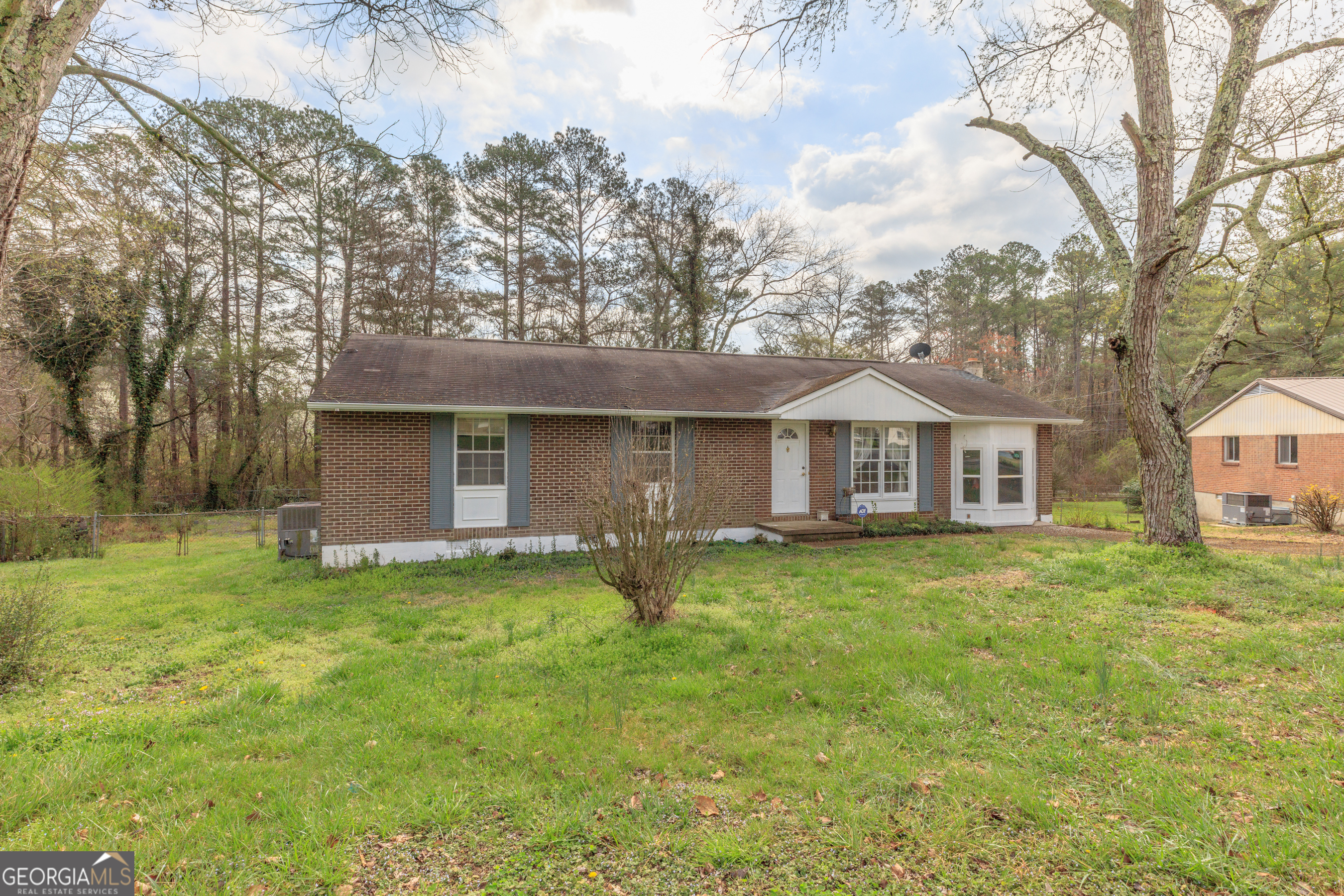 395 Wisteria Road LaFayette, GA 30728 - Photo 18 of 31 a front view of a house with a garden and trees