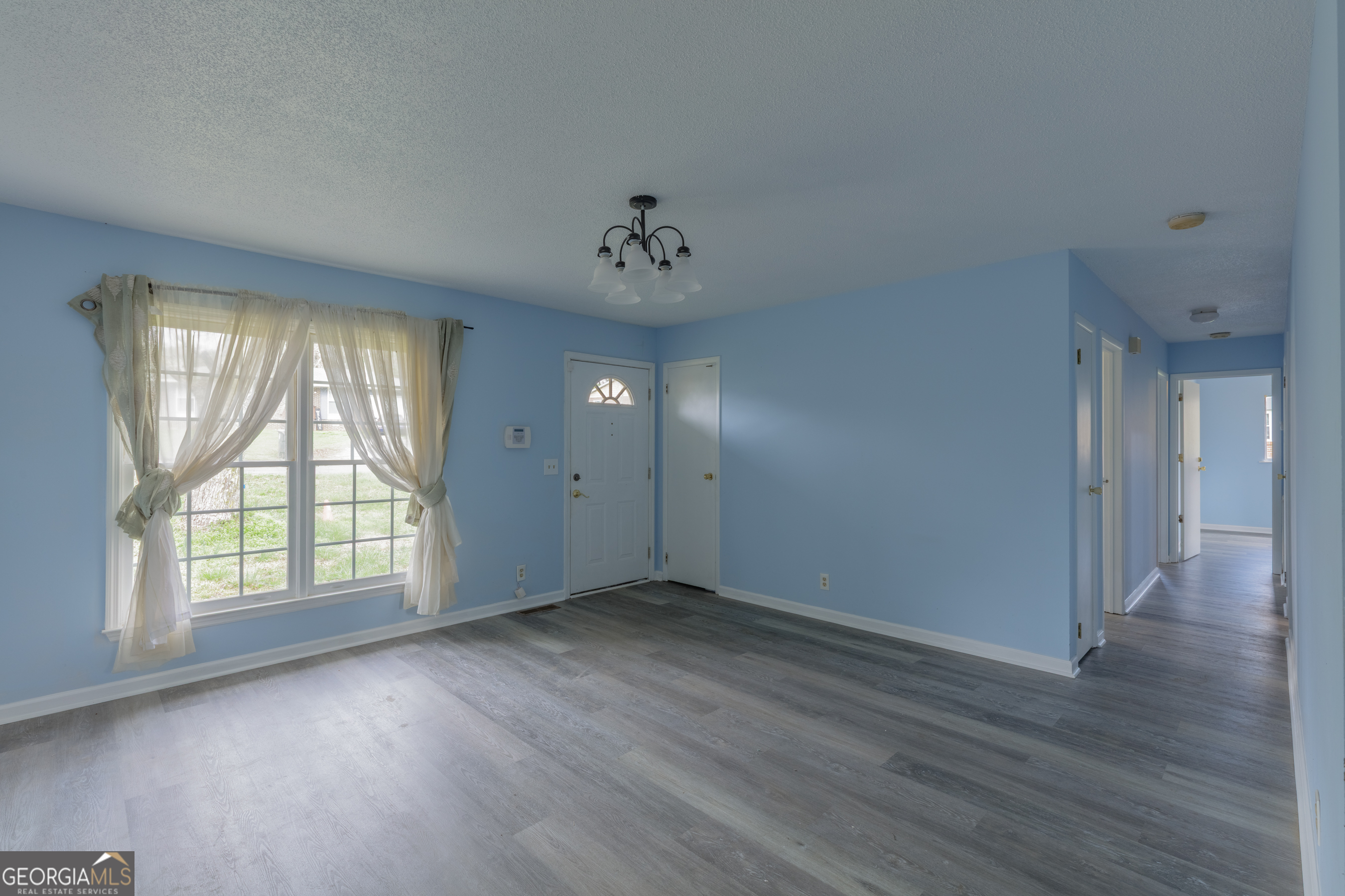 395 Wisteria Road LaFayette, GA 30728 - Photo 2 of 31 an empty room with wooden floor and windows