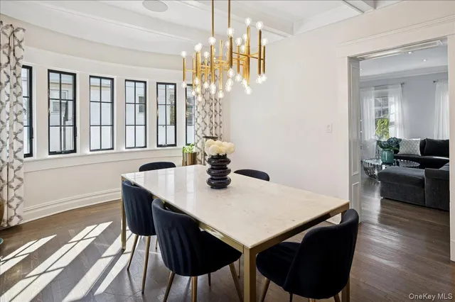 a view of a dining room with furniture a chandelier and wooden floor