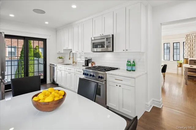 a kitchen with a stove a sink and a microwave