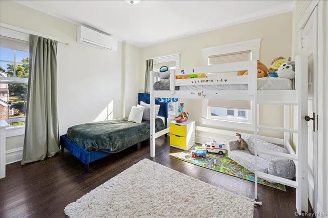 a bedroom with a bed and a wooden floor