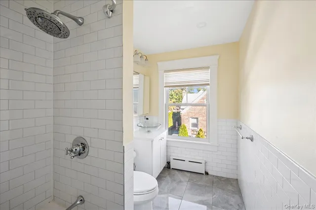 a bathroom with a toilet and shower