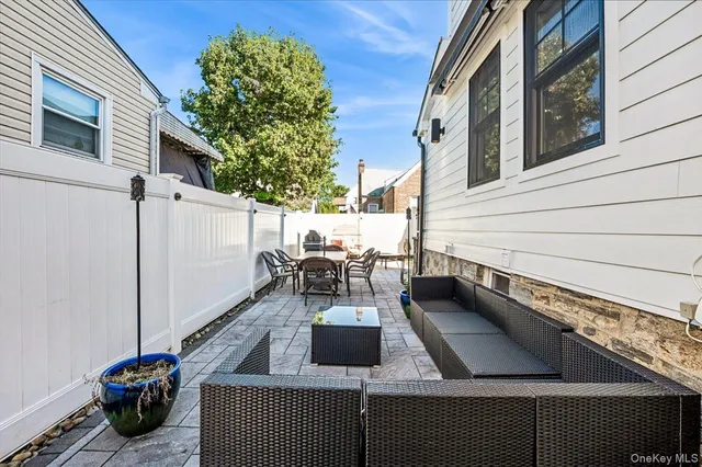 a view of a patio with table and chairs and potted plants