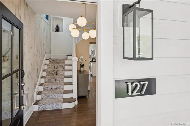 a view of a hallway with wooden floor and entryway