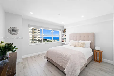 a bedroom with a bed and a potted plant