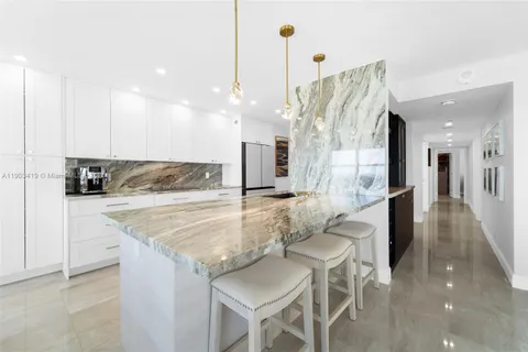 a kitchen with stainless steel appliances granite countertop sink and cabinets