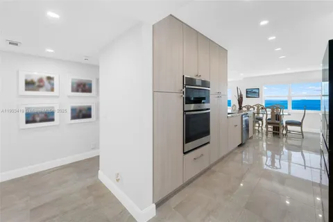 a kitchen with stainless steel appliances a refrigerator and a stove top oven