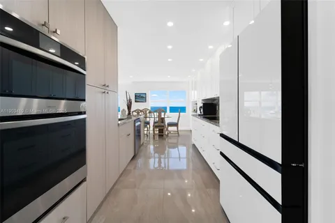 a view of a kitchen with kitchen island a sink wooden floor and a counter top space
