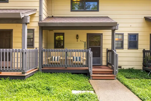 a view of a house with wooden fence